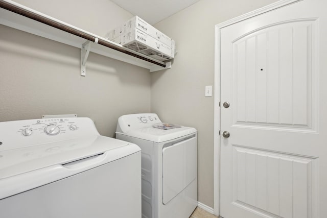 clothes washing area featuring independent washer and dryer