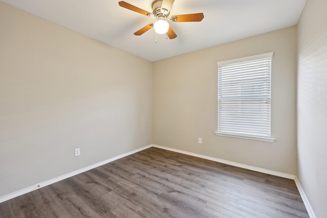 spare room with hardwood / wood-style floors and ceiling fan