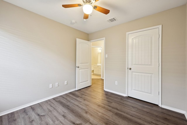 unfurnished bedroom with dark hardwood / wood-style floors and ceiling fan