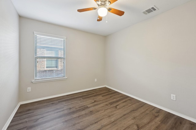 unfurnished room with ceiling fan and dark wood-type flooring