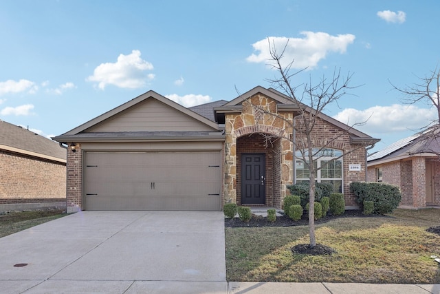 view of front of house featuring a garage and a front lawn