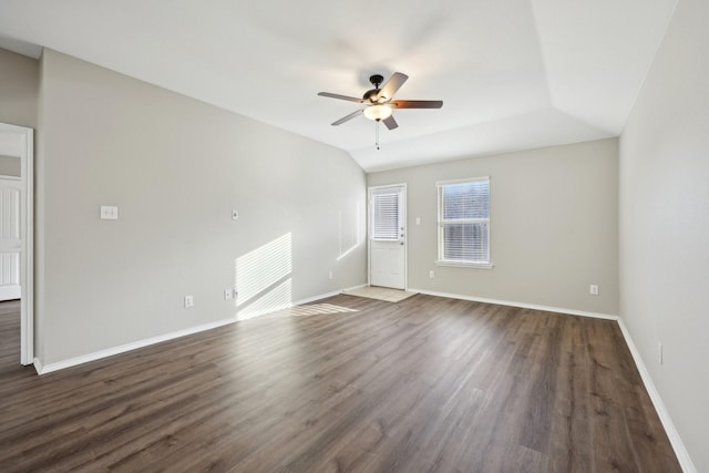 unfurnished room with dark hardwood / wood-style floors, vaulted ceiling, and ceiling fan