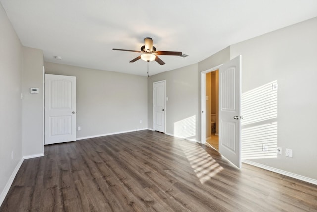 unfurnished room with ceiling fan and dark wood-type flooring