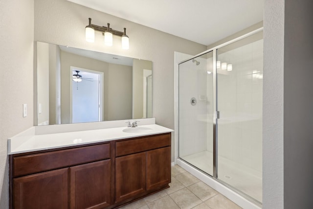 bathroom featuring walk in shower, vanity, tile patterned floors, and ceiling fan