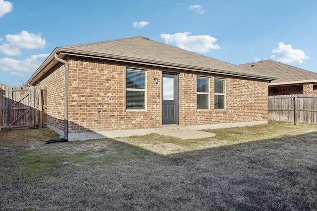 back of property featuring a lawn