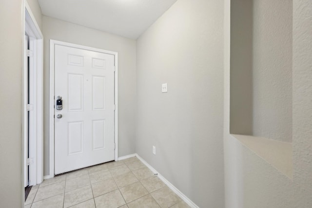 doorway to outside featuring light tile patterned floors