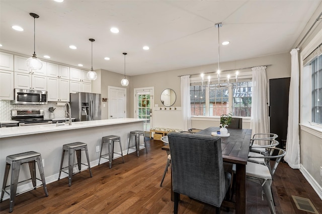 dining area featuring plenty of natural light, dark hardwood / wood-style floors, and sink