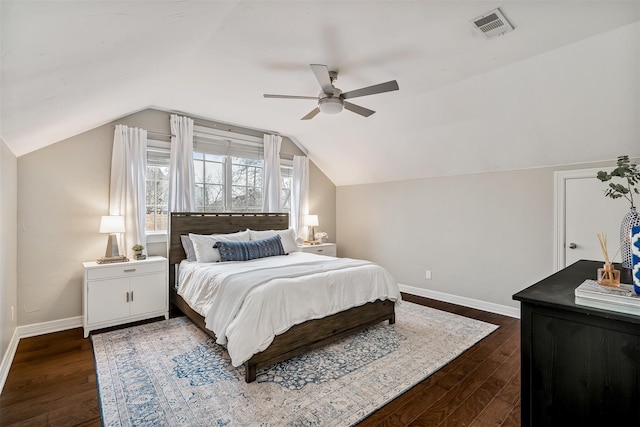 bedroom with vaulted ceiling, ceiling fan, and dark wood-type flooring