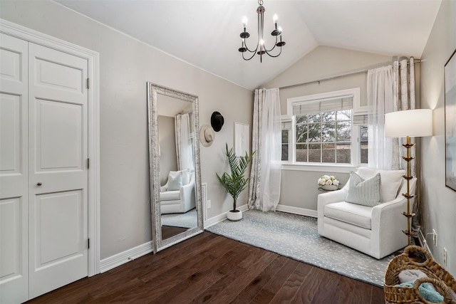 unfurnished room with a notable chandelier, dark hardwood / wood-style flooring, and vaulted ceiling