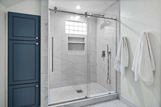 bathroom with a shower with door