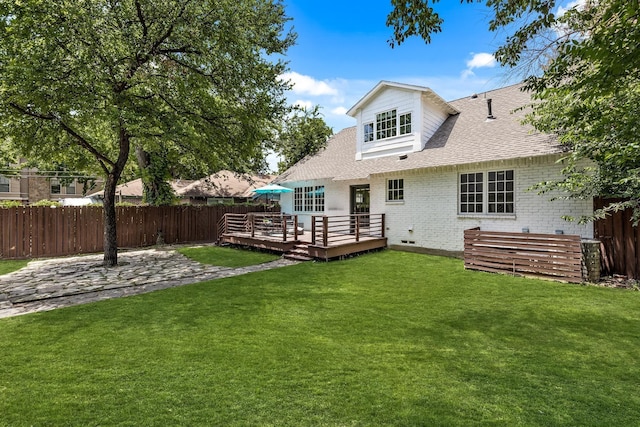 back of house with a yard and a deck