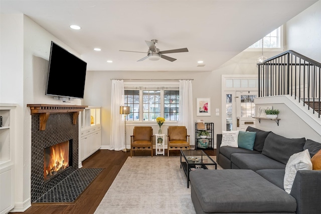 living room with dark hardwood / wood-style floors and ceiling fan