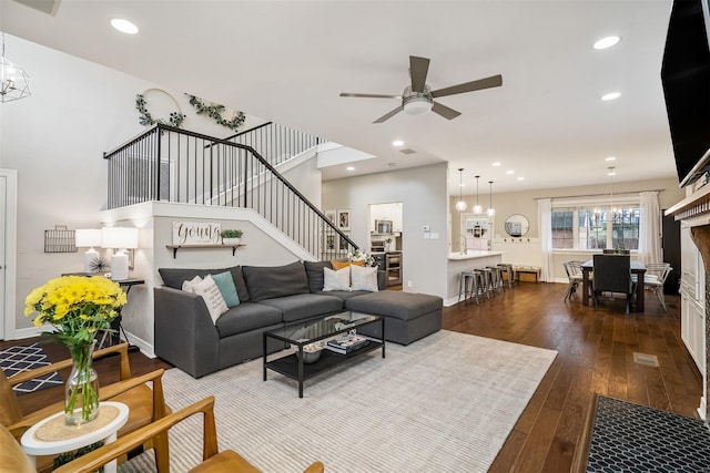 living room with wood-type flooring and ceiling fan