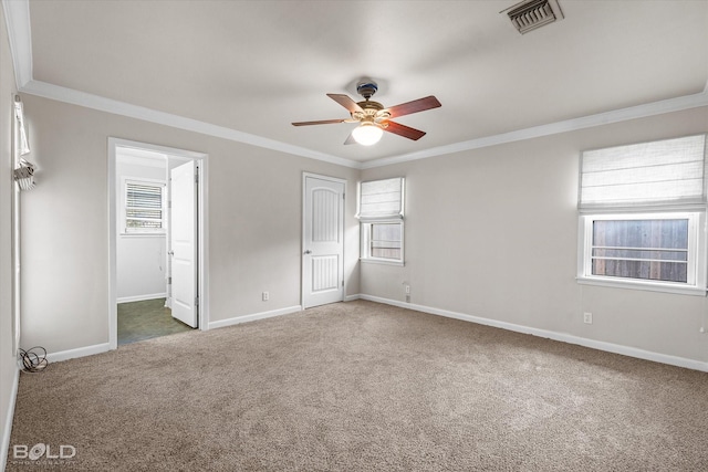 unfurnished bedroom featuring connected bathroom, dark colored carpet, ornamental molding, a closet, and ceiling fan