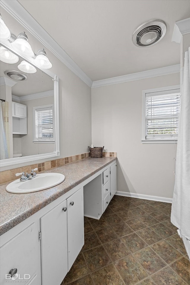 bathroom featuring vanity, plenty of natural light, and ornamental molding