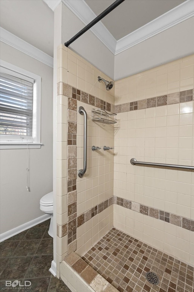 bathroom with tile patterned floors, ornamental molding, toilet, and tiled shower