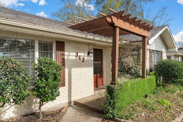 property entrance featuring a pergola