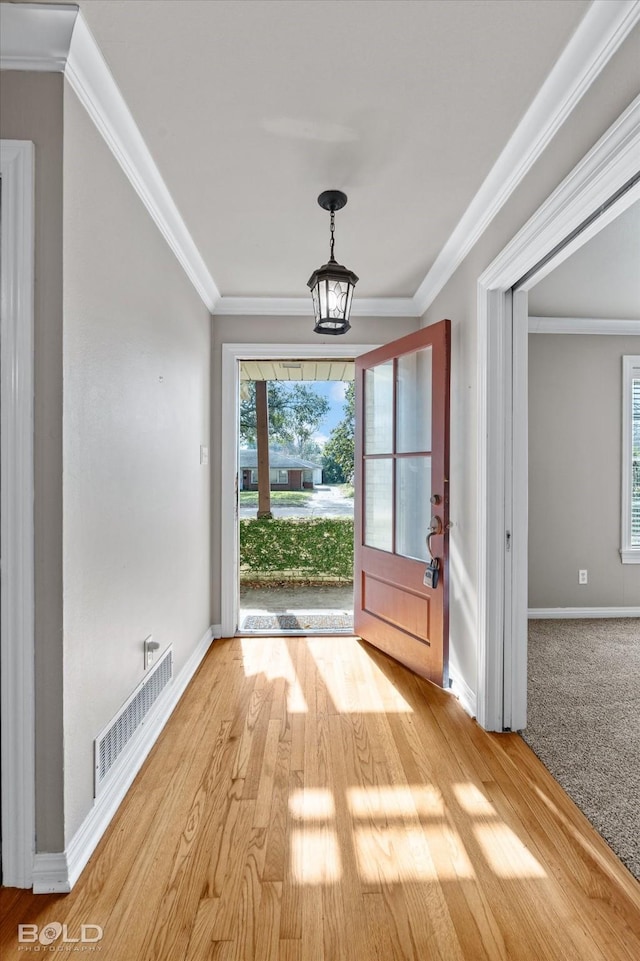 entryway featuring hardwood / wood-style flooring and crown molding