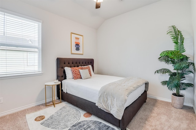 bedroom featuring multiple windows, ceiling fan, light carpet, and vaulted ceiling