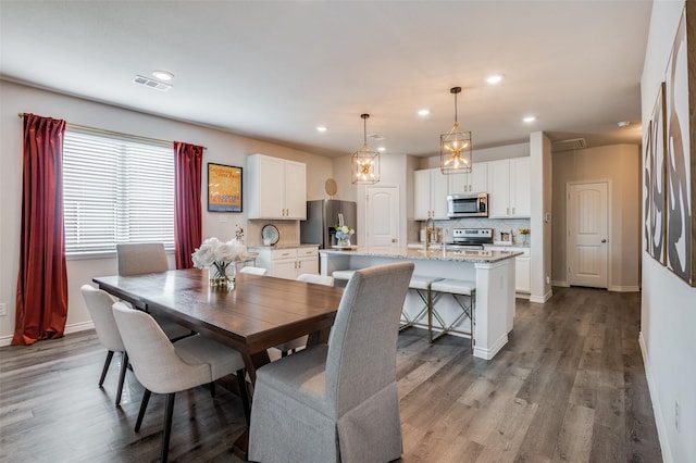 dining room with sink and wood-type flooring