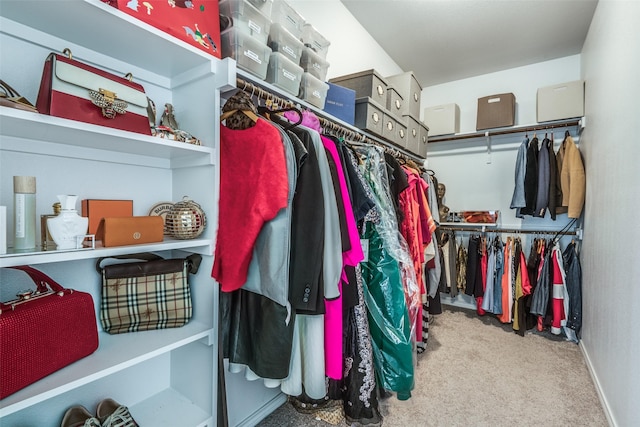 spacious closet featuring light colored carpet