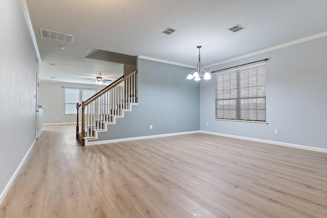 spare room featuring light hardwood / wood-style flooring, ceiling fan with notable chandelier, and ornamental molding