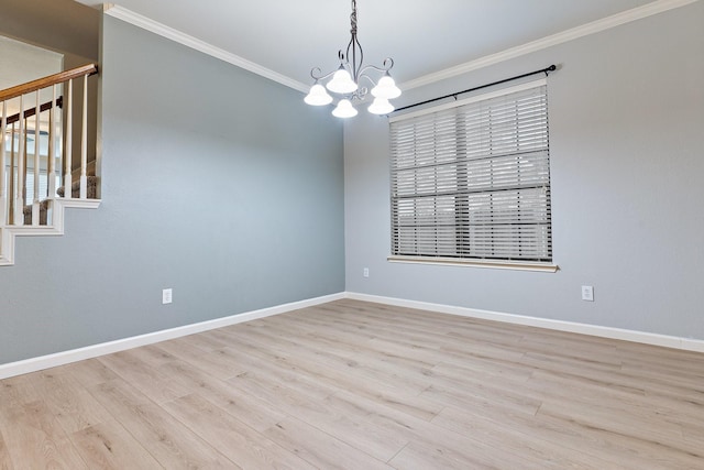 unfurnished room featuring ornamental molding, light hardwood / wood-style flooring, and an inviting chandelier