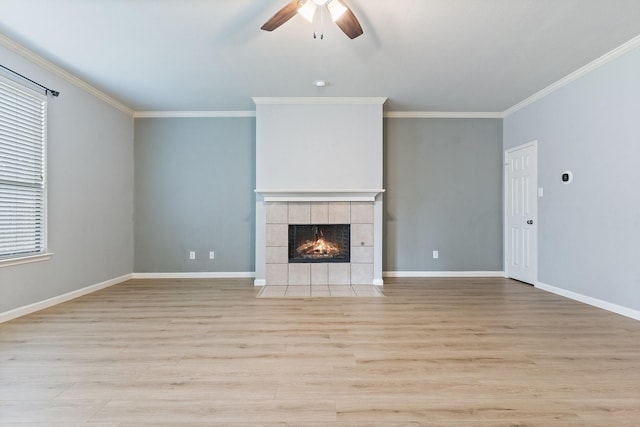 unfurnished living room with a tile fireplace, ceiling fan, light hardwood / wood-style floors, and ornamental molding