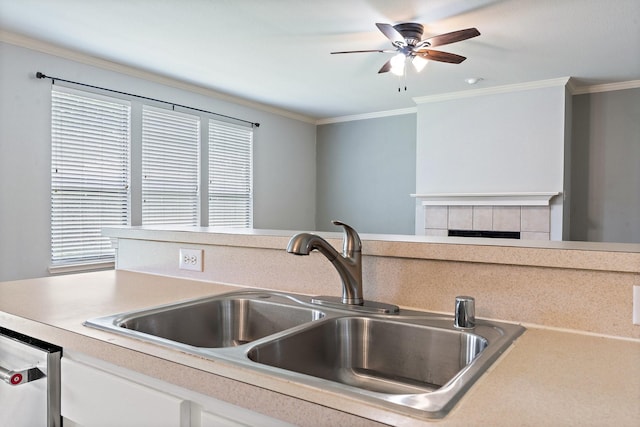 kitchen with white cabinetry, stainless steel dishwasher, ornamental molding, and sink