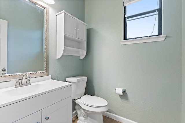 bathroom featuring vanity, hardwood / wood-style flooring, and toilet