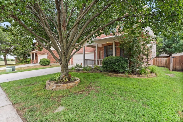 view of front of home with a porch, a garage, and a front lawn