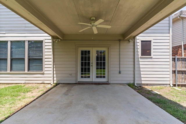 view of exterior entry featuring ceiling fan, french doors, and a patio