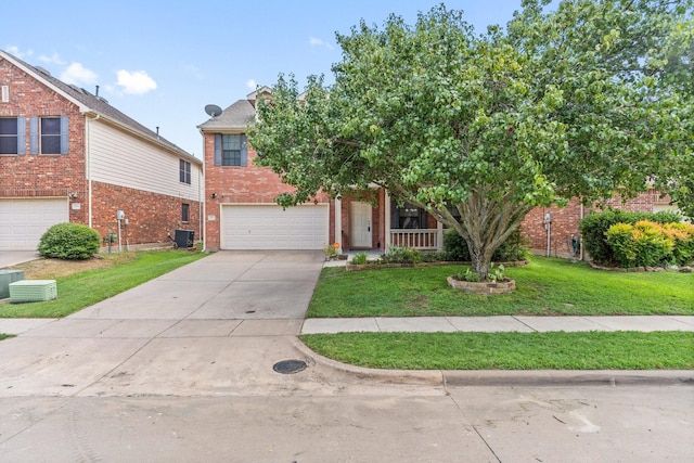 view of front of property with a porch, cooling unit, a garage, and a front yard