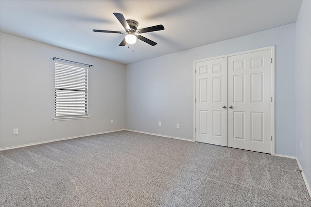 unfurnished bedroom featuring ceiling fan, a closet, and carpet floors