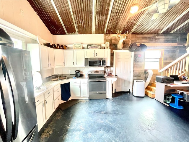 kitchen featuring white cabinetry, sink, wooden ceiling, and appliances with stainless steel finishes