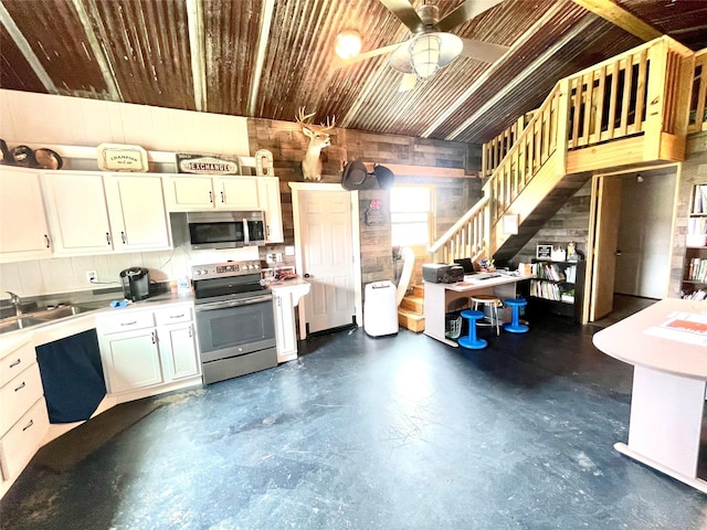 kitchen featuring white cabinetry, ceiling fan, appliances with stainless steel finishes, and sink