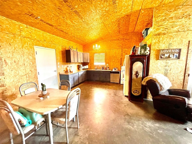 dining space with concrete flooring, vaulted ceiling, and a chandelier