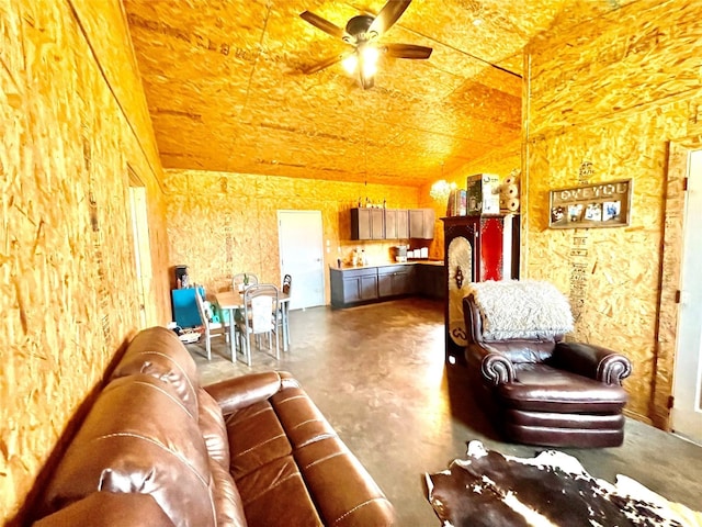 living room with ceiling fan and concrete floors