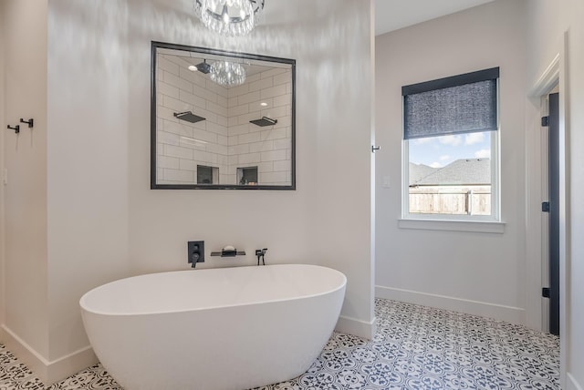 bathroom featuring tile patterned floors, a bathing tub, and a notable chandelier