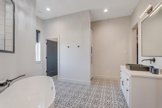 bathroom with vanity and a bathtub