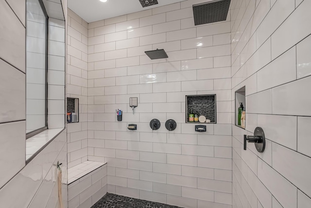 bathroom with tiled shower