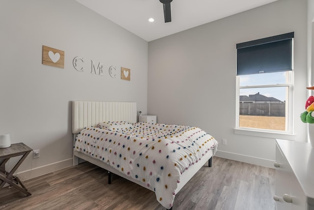 bedroom with radiator, ceiling fan, and hardwood / wood-style floors