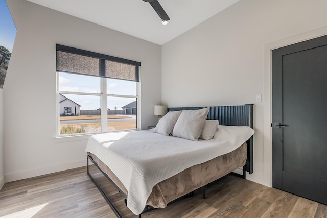 bedroom with ceiling fan and light hardwood / wood-style floors