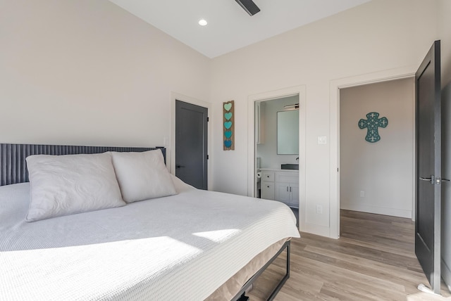 bedroom with ceiling fan, light hardwood / wood-style floors, and connected bathroom