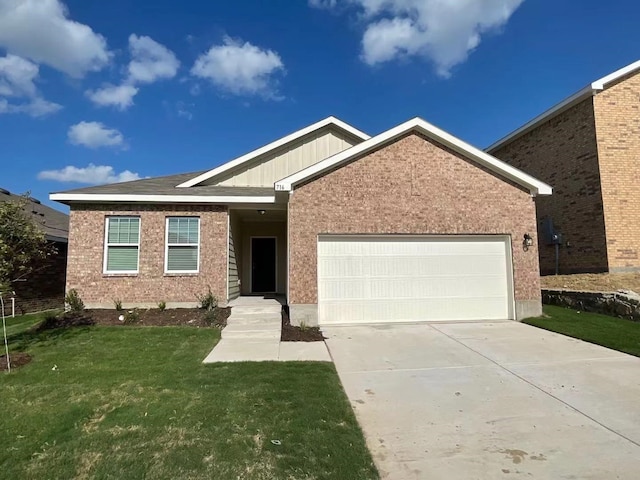 view of front of property featuring a garage and a front lawn