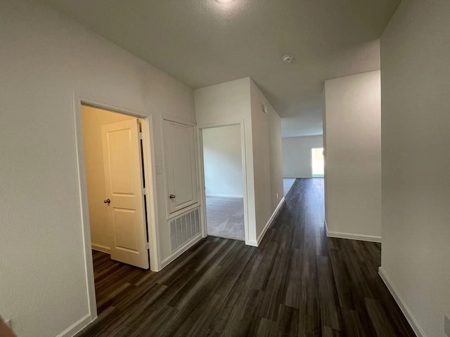 hallway with dark wood-type flooring