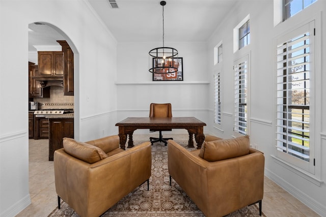 interior space with crown molding, light tile patterned flooring, and a chandelier