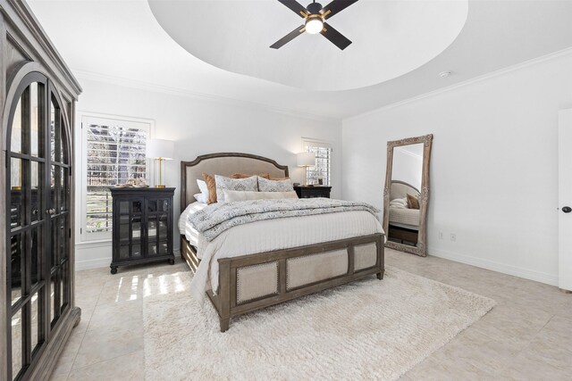 bedroom featuring a raised ceiling, ceiling fan, and ornamental molding