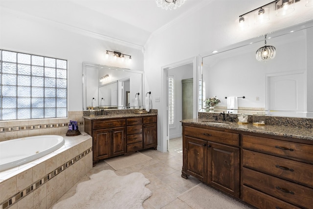 bathroom featuring vanity, crown molding, tile patterned flooring, tiled tub, and a chandelier