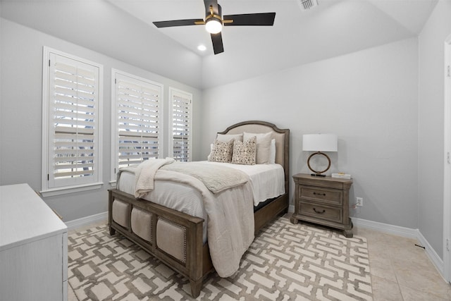 tiled bedroom with ceiling fan, lofted ceiling, and multiple windows